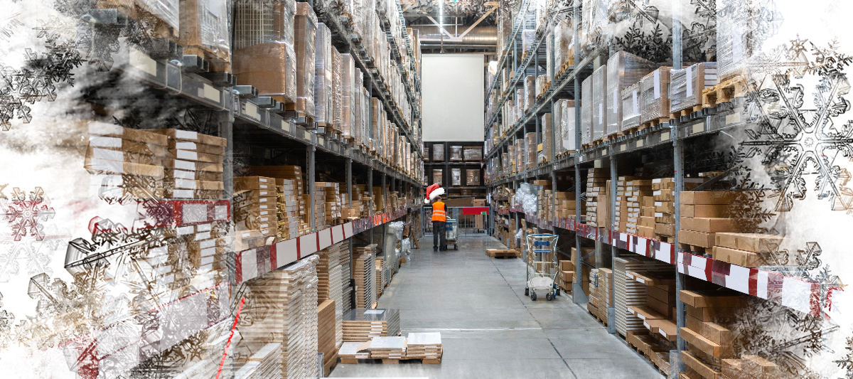 Photo of a man in a warehouse wearing a Santa hat.