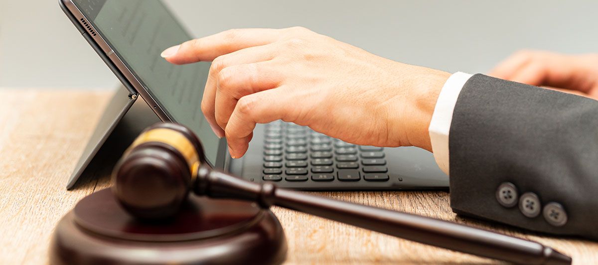 Picture of a Gavel next to a laptop