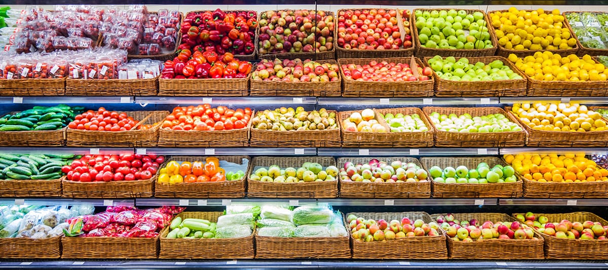 Photo of a supermarket produce department with baskets full of fruit and vegetables